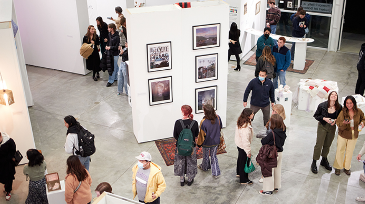 Overhead view of gallery visitors at the 2023 Graphic Design Senior Exhibition.